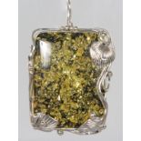 A GOOD SILVER MOUNTED AMBER PENDANT.