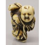 A GOOD SIGNED EARLY 19TH CENTURY JAPANESE EDO PERIOD CARVED IVORY NETSUKE OF A BOY, walking and