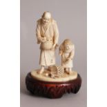 A FINE QUALITY SIGNED JAPANESE MEIJI PERIOD IVORY OKIMONO OF A FRUIT PICKER & HIS SON, together with