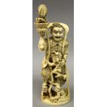 A GOOD QUALITY SIGNED JAPANESE MEIJI PERIOD GYOKUICHI IVORY OKIMONO OF A DEMON GOD, in the company