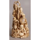 A GOOD SIGNED JAPANESE MEIJI PERIOD STAINED IVORY OKIMONO OF THE SEVEN LUCKY GODS, standing on and