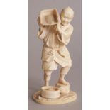 A SIGNED JAPANESE MEIJI PERIOD IVORY OKIMONO OF A FARMER, about to pour from a tray of grain on