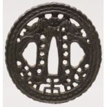 A JAPANESE MEIJI PERIOD IRON TSUBA, pierced with a design of confronting dragons, 2.3in x 2.25in