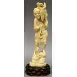 A SIGNED JAPANESE MEIJI PERIOD IVORY OKIMONO OF A FISHERMAN, together with a fitted wood stand,