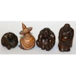 A GROUP OF THREE JAPANESE CARVED WOOD NETSUKE, the tallest 2.3in high; together with a small wood