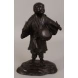 A JAPANESE MEIJI PERIOD BRONZE FIGURE OF A DRUMMER, his robes cast with a design of scrolling peony,