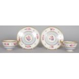 A FLIGHT BARR AND BARR WORCESTER PAIR OF TEA CUPS AND SAUCERS painted with roses and a light blue