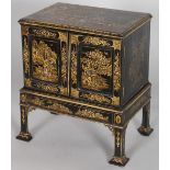 A GOOD GEORGE II DESIGN BLACK LACQUER TWO DOOR CABINET ON STAND, with chinoiserie decoration, the