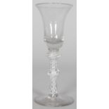 A GEORGIAN WINE GLASS with inverted bell bowl, white opaque twist stem with two knops. 6ins high.