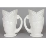 A PAIR OF WHITE GLASS FISH JUGS. 5.25ins high.