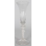 A TALL GEORGIAN WINE GLASS with long inverted bell bowl, air twist stem, with two knops. 8ins high.