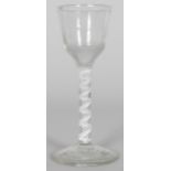 A GEORGIAN WINE GLASS with small bowl, and white opaque air twist stem. 5.5ins high.