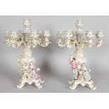 A PAIR OF DRESDEN STYLE PORCELAIN SEVEN LIGHT CANDELABRA with six scrolling branches, gallant and