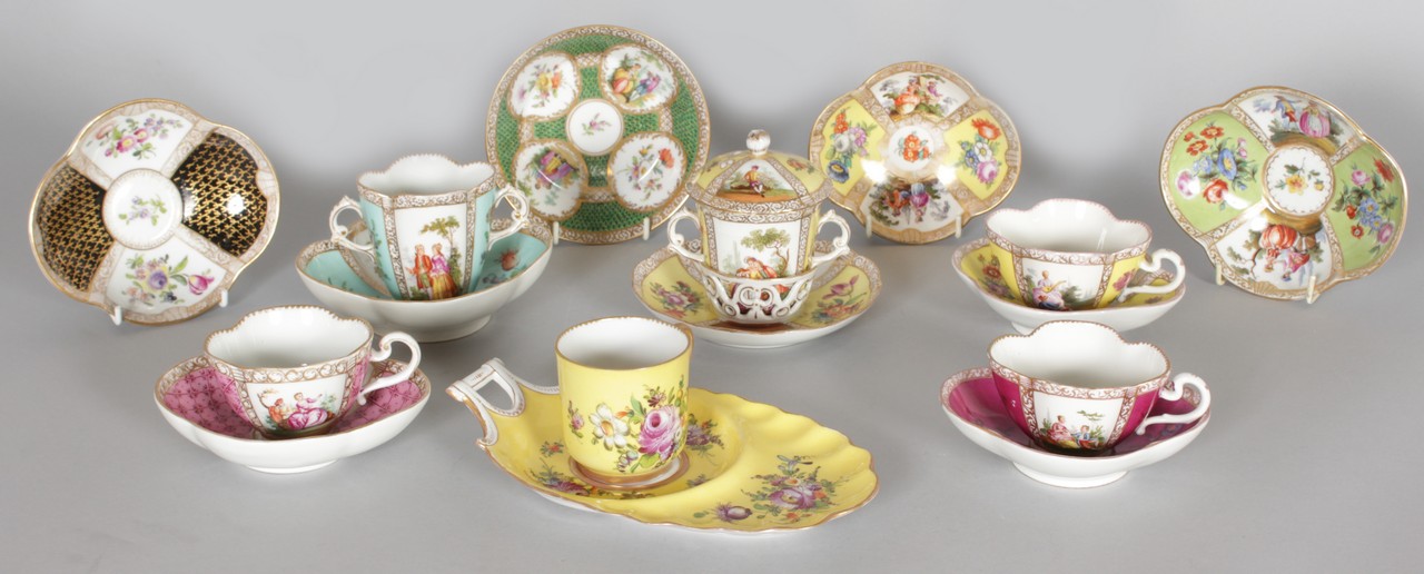 A DRESDEN "TRAMBLEUSE" CUP AND SAUCER, yellow ground with panels of figures and flowers; together