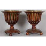 A PAIR OF DUTCH MAHOGANY JARDINIERES, each with a brass liner on a turned base. 1ft 4ins high.