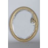 AN ART DECO GILT METAL OVAL MIRROR with a young lady. 13ins high, 10ins wide.