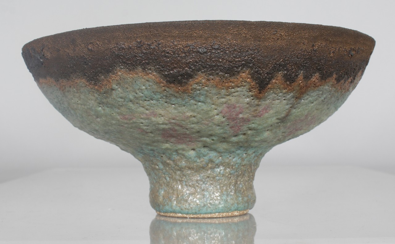 DAME LUCIE RIE (1902-1995) AUSTRIAN A FOOTED CIRCULAR BOWL with volcanic glaze. Impressed Mark. 8.