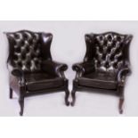 A GOOD PAIR OF GEORGE III DESIGN LEATHER WING ARMCHAIRS, on carved cabriole legs.