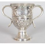 A GEORGE III TWO HANDLED PEDESTAL LOVING CUP with floral repousse decoration. London 1774. Maker