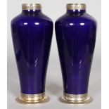 A PAIR OF CONTINENTAL SILVER AND PORCELAIN VASES, of tapering form with embossed silver rim and foot