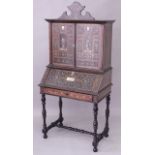 AN 18TH CENTURY ITALIAN EBONISED AND INLAID CABINET / BUREAU with a shaped cresting above a pair