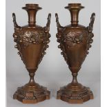 A GOOD PAIR OF 19TH CENTURY BRONZE URN SHAPED LAMP BASES, with removable tops, the twin handles