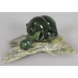 A GLASS BEAR with young, and a fish on an agate base. 4.5ins long.
