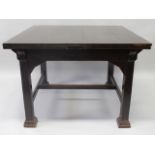 AN ARTS AND CRAFTS OAK DRAW LEAF TABLE, CIRCA. 1900, with a dark stained finish, the square top