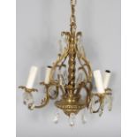 A LATE 19TH CENTURY BRONZE CHANDELIER, with four scrolling branches with cut glass drops. 1ft 6ins