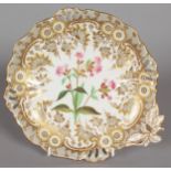 A BOTANICAL SHELL SHAPED DISH painted with a sprig of flowers, with pierced border. 10ins long.