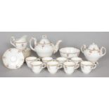 A TEA SERVICE, edged in gilt and painted with red roses, comprising teapot and cover, sucrier and