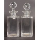 A PAIR OF PLAIN WHISKY DECANTERS AND STOPPERS.