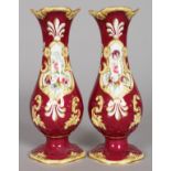 A PAIR OF RED GROUND VASES painted with panels of flowers. Pattern No. 3/1538, Col No. 320. 8.5ins