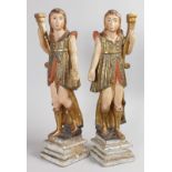 A GOOD PAIR OF 18TH CENTURY SANTOS CARVED POLYCHROME FIGURES on stepped bases. 25ins high.