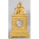 A GOOD FRENCH EMPIRE ORMOLU MANTLE CLOCK, surmounted by a seated scribe, the case with scrolls and