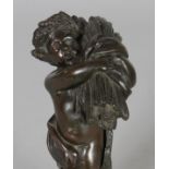 A GOOD SMALL 19TH CENTURY FRENCH BRONZE PUTTI depicting Autumn, on a marble base. 7.5ins high.