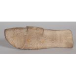 AN EARLY CARVED STONE FISH HANDLE. 8.5ins long.