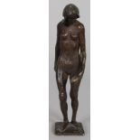 A BRONZE OF A STANDING NUDE, holding a shell in her left arm. 7.25ins high.