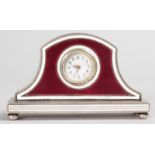 A LOVELY SILVER, PURPLE ENAMEL AND WHITE ENAMEL DOMED DESK CLOCK on bun feet. 3.5ins long, 2ins