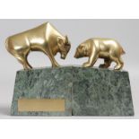 A BRONZE POLAR BEAR AND BUFFALO, Given to MERRILL LYNCH by THE BANK OF AMERICA, on large marble