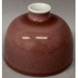 A CHINESE PEACH BLOOM PORCELAIN WATER POT, applied with a pale mottled glaze, the base with a six-