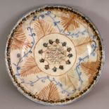 A 19TH/20TH CENTURY ISLAMIC GLAZED POTTERY DISH, of saucer shape, painted to its centre with a panel