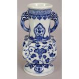 A CHINESE MING STYLE BLUE & WHITE PORCELAIN VASE, decorated to its facetted square section central