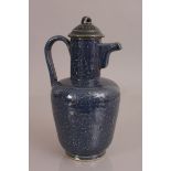 A CHINESE YUAN STYLE BLUE GLAZED EWER & COVER, the sides decorated in white slip reserve with formal