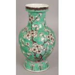 A 19TH CENTURY CHINESE GREEN GROUND PORCELAIN VASE, painted in black, aubergine and white reserve