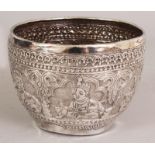 A SOUTH-EAST ASIAN EMBOSSED SILVER METAL BOWL, unmarked, weighing 335gm, the sides decorated with