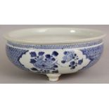 A CHINESE BLUE & WHITE PORCELAIN TRIPOD CENSER, the sides painted with barbed panels of foliage