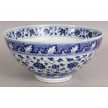 A CHINESE MING STYLE BLUE & WHITE PORCELAIN BOWL, the sides decorated with formal scrolling lotus