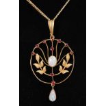 AN EDWARDIAN 15CT YELLOW GOLD, OPAL AND RUBY SET PENDANT on a chain.