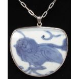 A SILVER MOUNTED MING BLUE AND WHITE PENDANT on a chain.